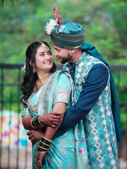 A beautiful candid shot of the couple sharing a look. The bride's light blue saree and the groom's matching attire create a harmonious and visually pleasing portrait.