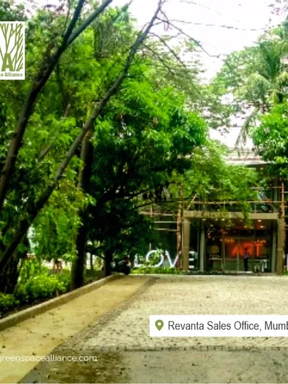 The entrance to the Revanta Sales Office is framed by mature trees and a welcoming pathway. This design creates a tranquil and impressive arrival experience, immediately conveying a sense of luxury and connection to nature.