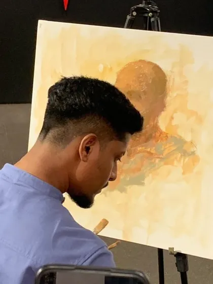 Another angle from the demonstration at Kamalnayan Bajaj Art Gallery, showing the portrait in its early stages. The warm, yellow-toned underpainting helps create a sense of light and harmony in the finished work.