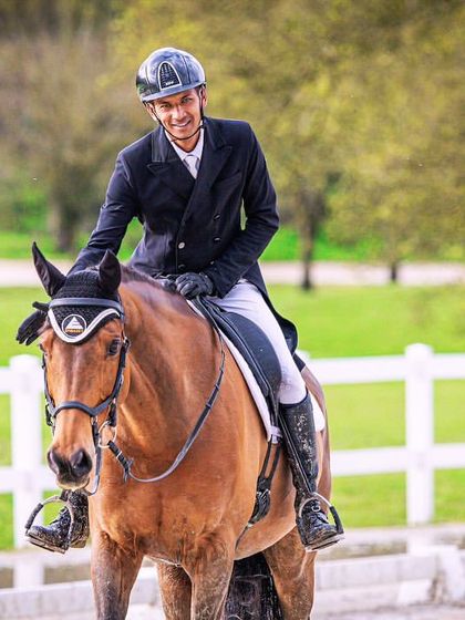 A smiling rider and his horse after a successful CCI 3* event in Sopot, Poland. This image captures the joy of international victory and qualifying for the Asian Championship.