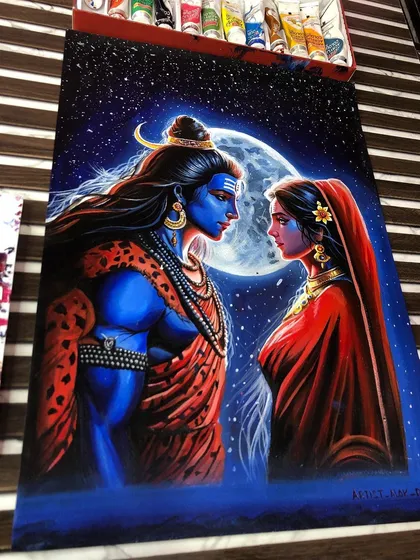 The finished painting on my work table, surrounded by my acrylic paints. The deep blues and reds create a beautiful contrast.