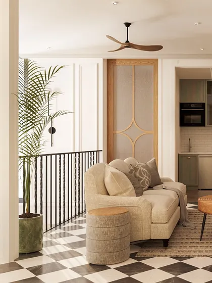A closer look at the family lounge reveals the interplay of textures, from the plush sofa to the woven side table. A large palm plant adds a touch of nature, softening the graphic quality of the checkered floor and enhancing the room's warm feel.