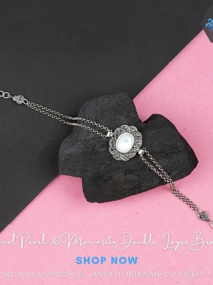 A unique double-layer bracelet with a central mother-of-pearl and marcasite motif. This design adds depth and interest to your wrist.