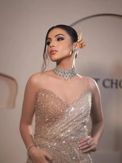 A sparkling champagne gown styled for a gala event. I paired it with a delicate emerald and diamond choker to add a touch of color and sophistication.