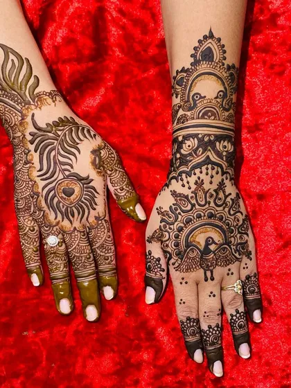A creative and artistic design featuring peacock motifs in different styles. One hand showcases a peacock feather heart, while the other has a peacock inside a decorative frame.