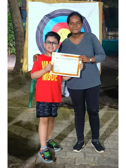 A proud moment for this young archer and his coach after completing the May 2023 summer camp.