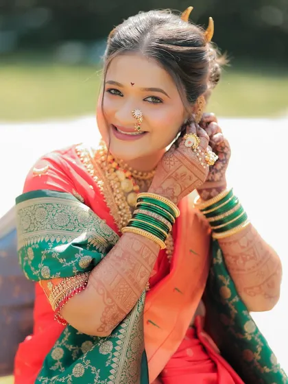 A radiant Maharashtrian bride on her wedding day. Seeing my work as part of a bride's complete look, complementing her beautiful saree and jewelry, is the most rewarding part of what I do.