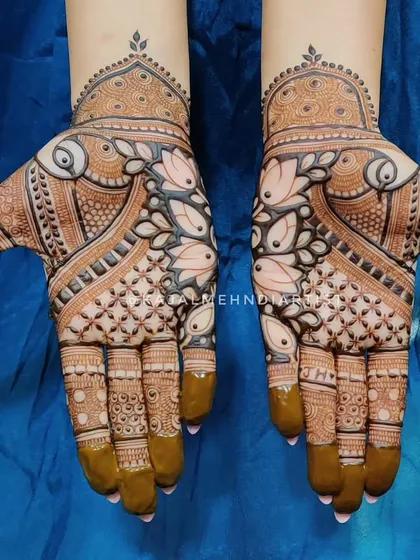 A classic Indian henna design with a focus on symmetry and traditional motifs like the lotus and paisley.