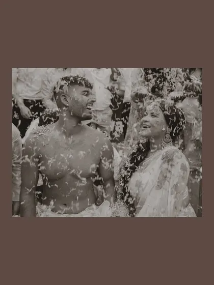 Even in black and white, the joy is colorful. This timeless photo focuses on the pure happiness shared between the couple during their Haldi, with laughter that feels completely genuine and unposed.