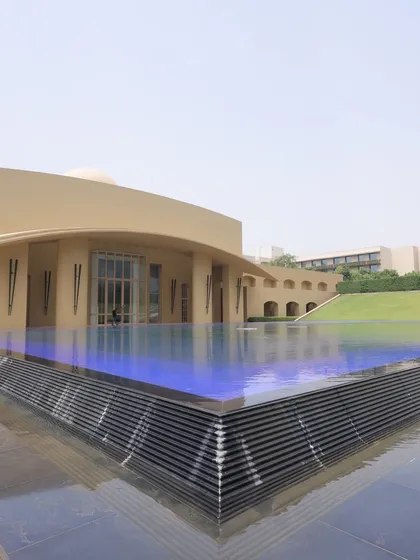 The poolside area of a resort, often used for pre-wedding functions or destination weddings. The modern architecture and water body make for great photos.