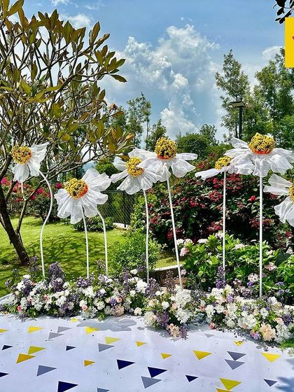 A whimsical and fun photo corner with oversized, artistic sunflowers, perfect for brightening up a special day and creating memorable pictures.