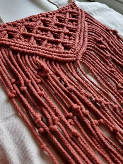 A side view of the macrame panel on my tote bag, showing the texture and fringe against the canvas.