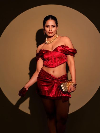 A powerful stance in a red co-ord set, framed by a perfect circle of light. This is a great example of how we use lighting equipment to create graphic, impactful compositions.