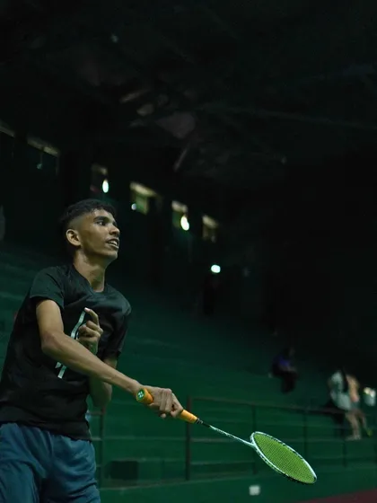 A player focused on a net shot, demonstrating the precision and control we teach.