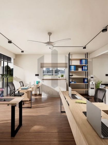 This view of the Noir Oak office highlights the open workstation layout. The desks are arranged to foster quiet connection, close enough for collaboration but spaced for individual focus. The large window and track lighting ensure the space is always bright and visually clean.