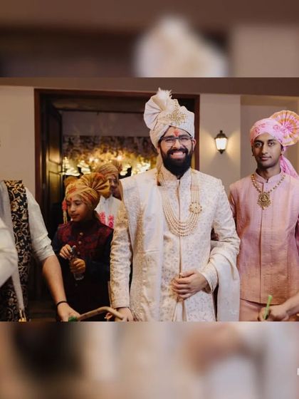 The groom's procession. Our client, smiling brightly, is surrounded by family and friends, looking absolutely regal in his wedding day sherwani.