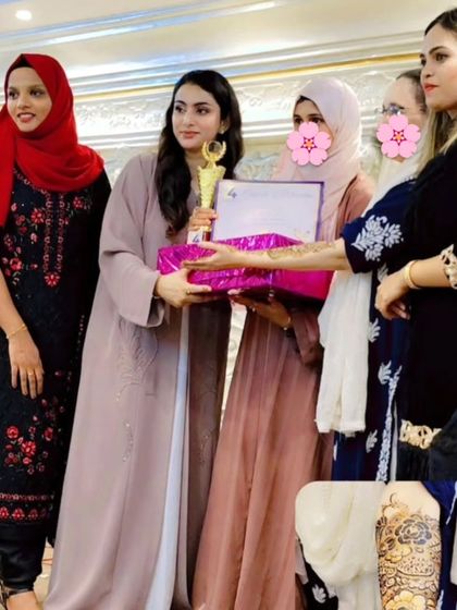 A proud moment, receiving my award at the mehendi contest. I'm so grateful for the support and recognition.