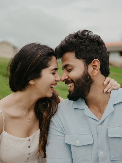 A moment of pure, unscripted laughter. Nishant and Aishwarya's pre-wedding shoot in a serene meadow is all about capturing their natural connection and joy.