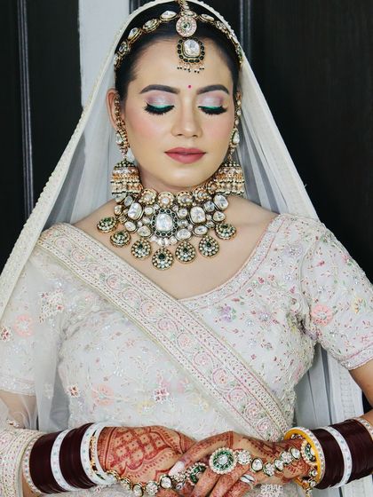 A serene portrait with eyes closed, focusing on the flawless makeup application.