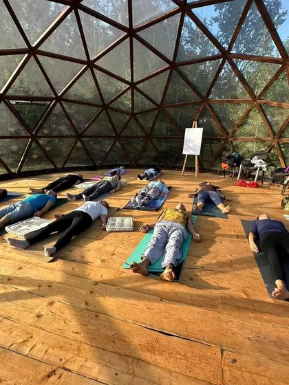 Every class ends with Savasana (Corpse Pose), the most important asana for integration and deep rest. Here, students lie peacefully, allowing the benefits of the practice to settle into their bodies and minds.