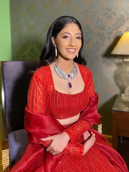 A gorgeous cocktail look for Pooja in a stunning red gown. The makeup is kept classic and elegant, with defined eyes and a soft lip.