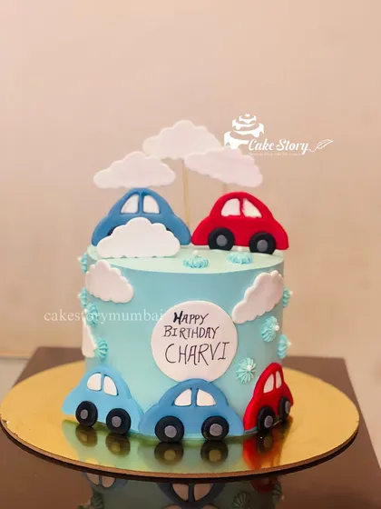 A simple and cute car-themed cake. Decorated with colorful fondant cars and fluffy clouds, it's a great choice for a little one who loves vehicles.