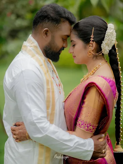 A quiet and intimate embrace with the couple's foreheads touching, set against a soft green background. This portrait focuses purely on their emotional connection.