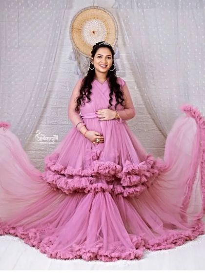 This pink ruffle gown is one of my most popular maternity rental options. The unique design with flowing side panels creates a beautiful, wide silhouette for photos.