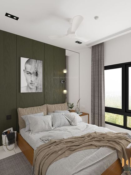 A different angle of the bedroom, showing the dark green laminate paneling behind the bed, complemented by modern art.