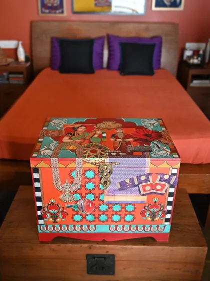 My custom memory boxes are designed to hold your most precious keepsakes. This piece, crafted from salvaged teak, uses decoupage and hand-painting to weave together themes of colonial-era portraiture and traditional Indian jewelry, making it a personal treasure chest.