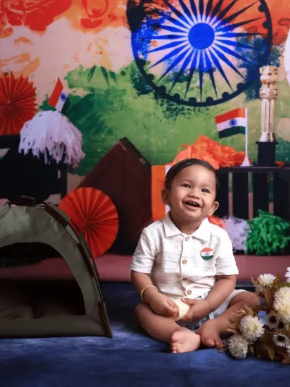A happy smile for Independence Day! This little patriot is sitting in our festive setup, complete with tricolor decorations and a miniature tent, celebrating the spirit of the nation.