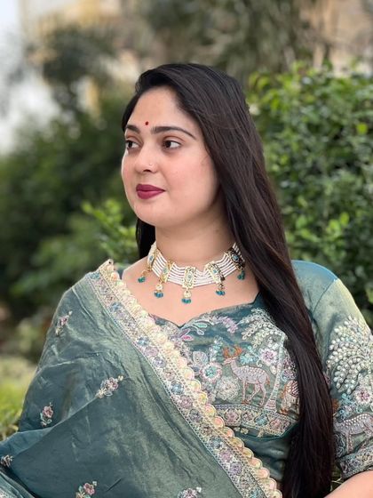 A model showcasing the elegance of the 'Apsara' necklace. See how this choker sits beautifully on the neckline, adding a touch of grace to this traditional attire.