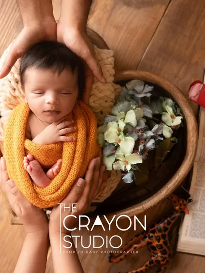 Adventure awaits this little explorer. Surrounded by vintage toys, maps, and books, this travel-themed newborn setup is a creative way to celebrate the grand journey that lies ahead for this new life.