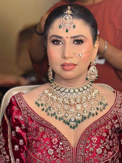 A slightly different angle of the same bride, showing the makeup and hair being finalized. It gives a glimpse into the getting-ready process.