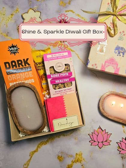 The Shine & Sparkle Diwali Gift Box, featuring a wooden candle, healthy rose pops, and dark chocolate, all in a beautifully designed festive box.