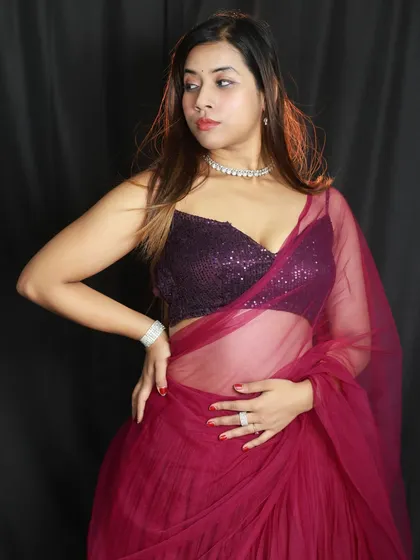 A three-quarter shot showcasing the sheer dupatta and the sequined blouse. The lighting is set to highlight the different textures of the fabric.
