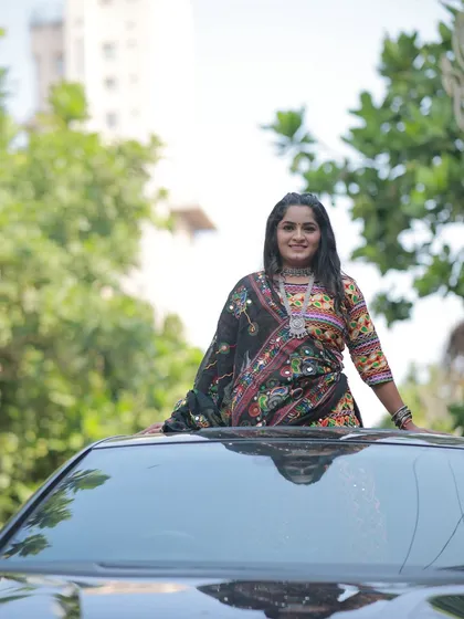 A fun and modern shot for a Navratri look. The colorful outfit and joyful expression capture the spirit of the festival perfectly.