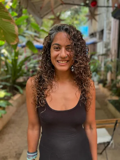 A happy client with her freshly colored curls. The non-bleach highlights give her a beautiful, natural glow.