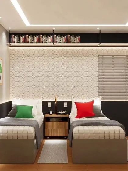 The sleeping area of the Mario-themed room, with twin beds and a shared nightstand. The geometric wallpaper and overhead bookshelf add to the modern design.