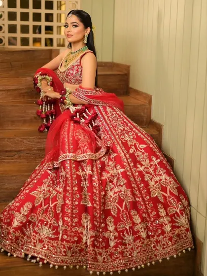 Seated gracefully, the lehenga's drape creates a beautiful cascade of fabric. I always consider how the outfit will look in photos, whether you are standing, sitting, or walking.