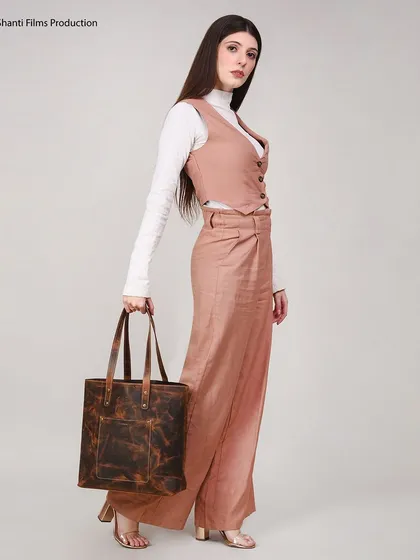 This lifestyle photograph for a leather tote bag shows how we place products in a fashion context. We focus on creating a complete look that helps customers visualize themselves using the product.