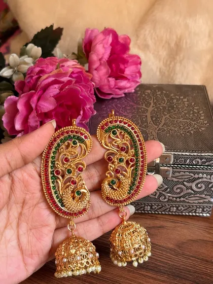 Another angle of the peacock earrings, showing the intricate design of the jhumka.