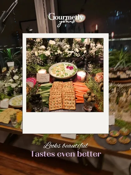 "Looks beautiful, tastes even better." A polaroid-style shot of a dip platter with fresh vegetable sticks and crackers, highlighting our fresh and vibrant offerings.