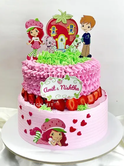 A classic Strawberry Shortcake theme brought to life on a two-tiered cake. This design uses fresh strawberries and detailed piping work for a nostalgic and delicious result.