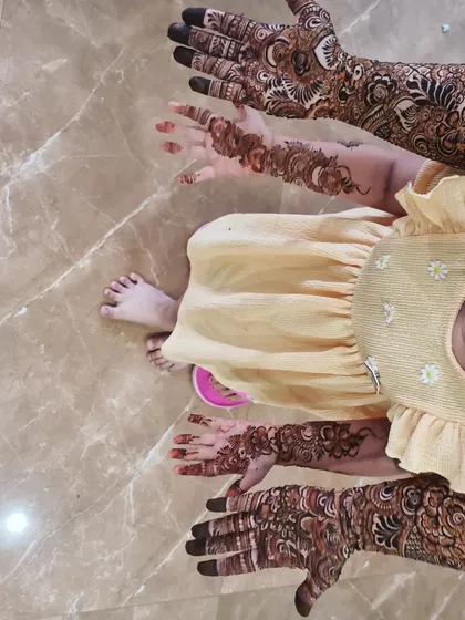 Mother and daughter showing off their henna together! It's so special to create these matching moments for families.