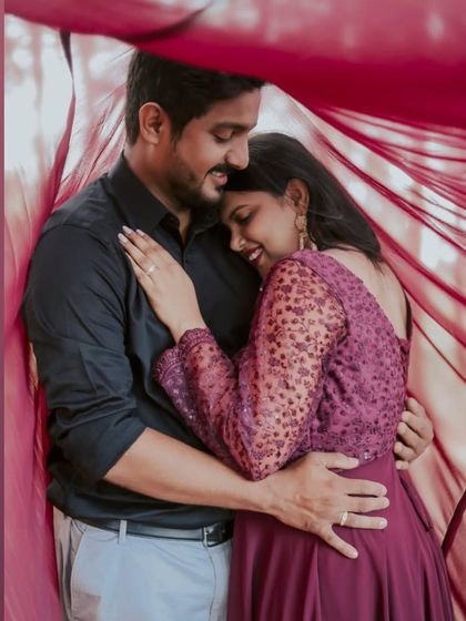 An intimate embrace under the veil of her gown. This wine-colored dress creates a cozy and romantic pre-wedding photo.
