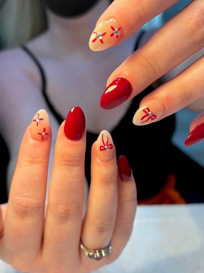 A candid shot of the Christmas-themed nail art, showcasing the delicate bow and floral patterns.