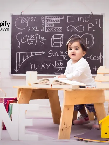 A little scholar is turning one! This creative 'back to school' themed birthday shoot is so much fun, with a tiny desk, a chalkboard of equations, and a globe.