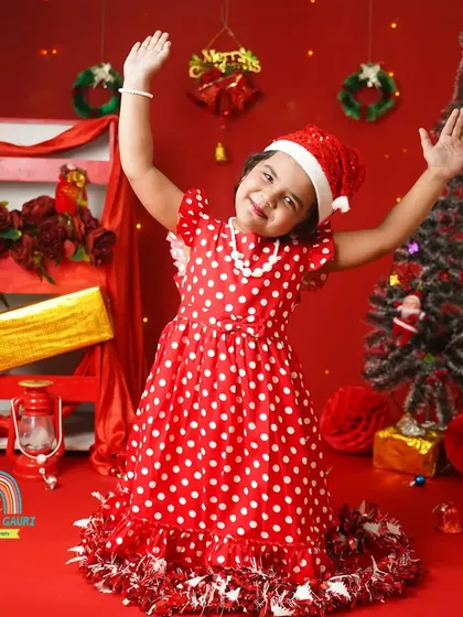 Hands up for Christmas. This little girl is full of energy and festive cheer during her holiday photoshoot.