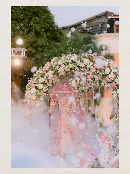 A truly magical bridal entry. The bride appears through a cloud of smoke and bubbles, creating a dramatic and unforgettable moment as she walks towards the mandap.